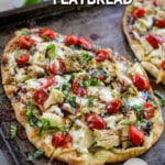 Caprese chicken flatbread on a sheet pan.