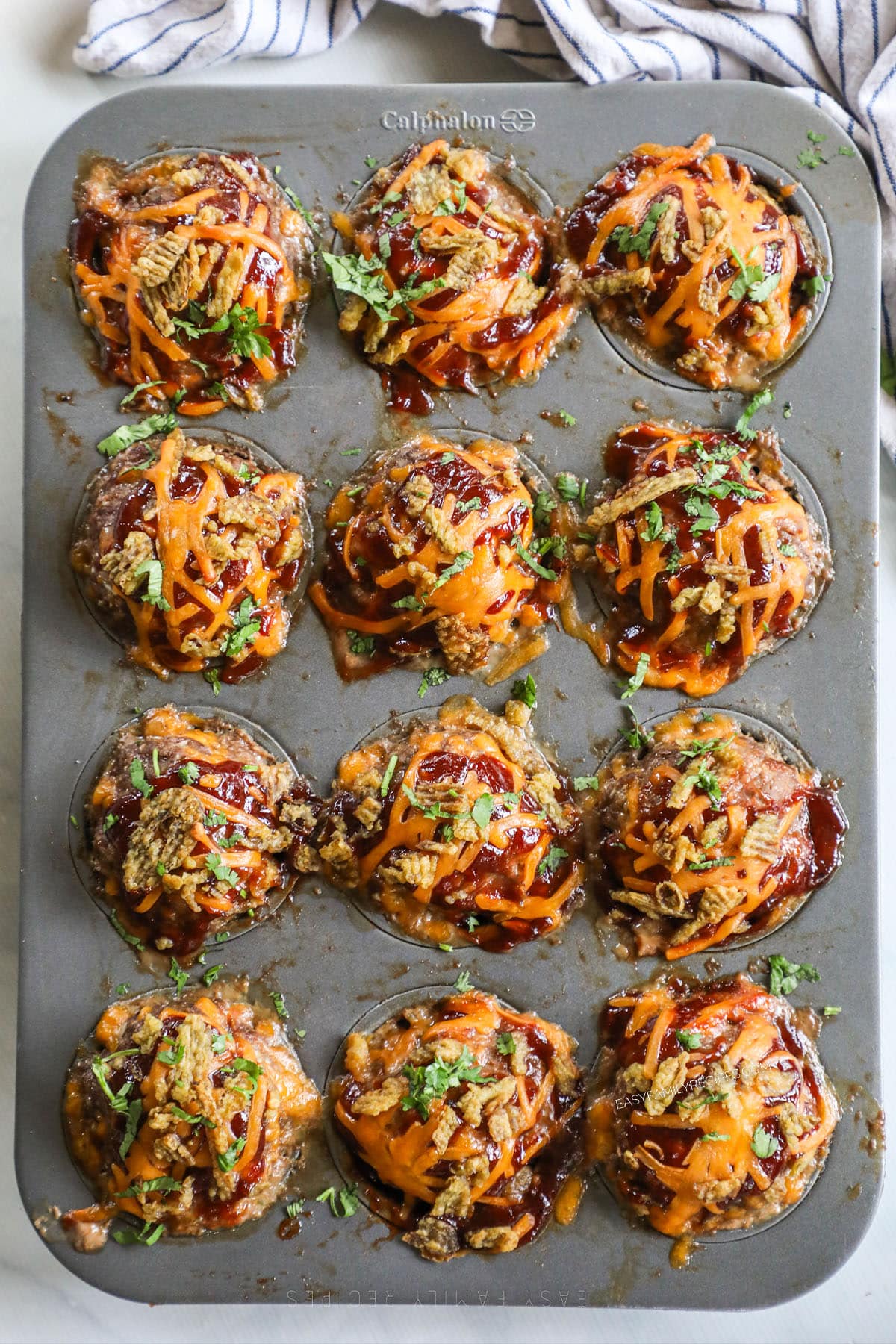 Barbeque and cheese meatloaf muffins after baking in a muffin pan.