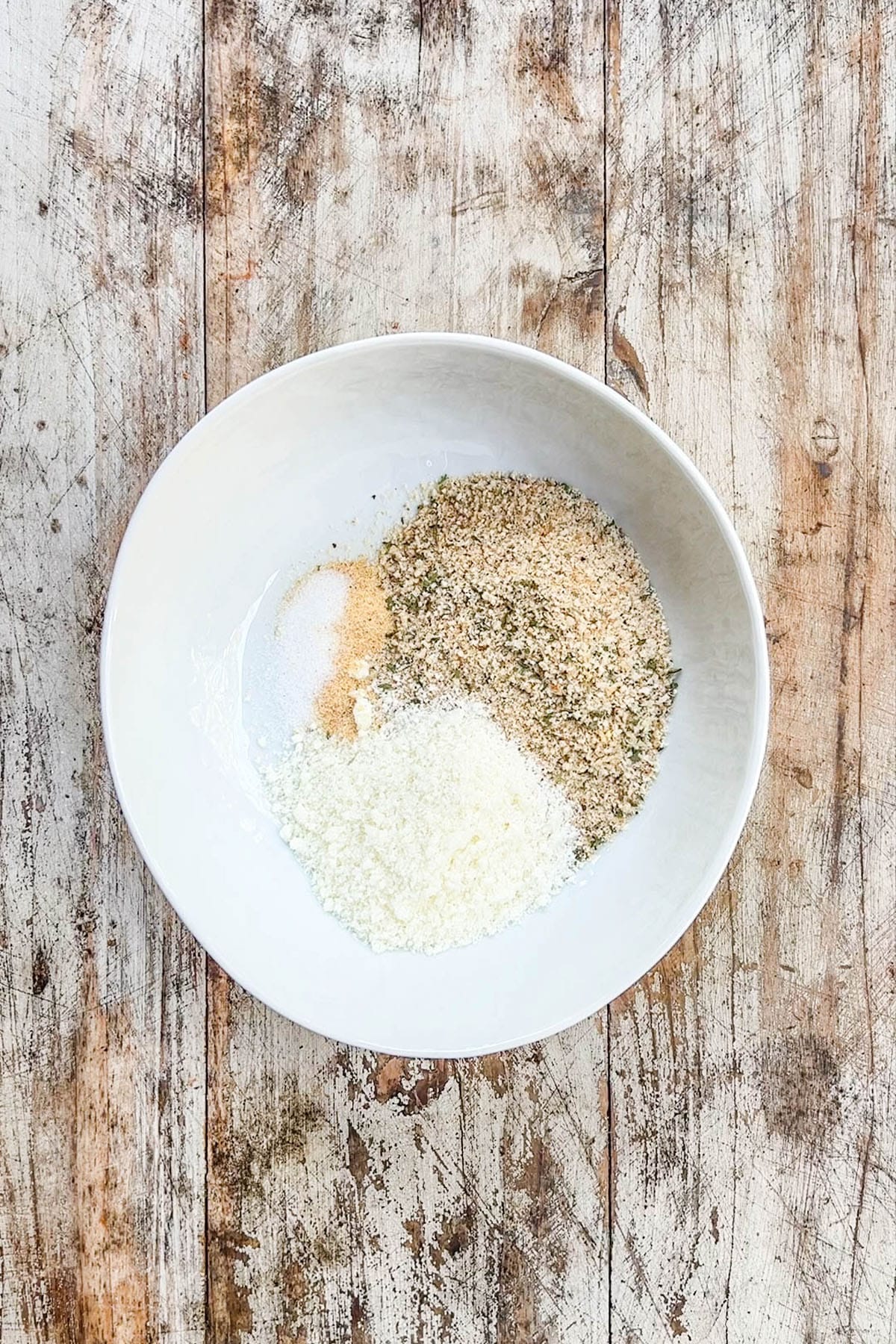 A top view of the ingredients for garlic Parmesan bread crumbs in a white bowl for Garlic Parmesan Chicken Pasta.