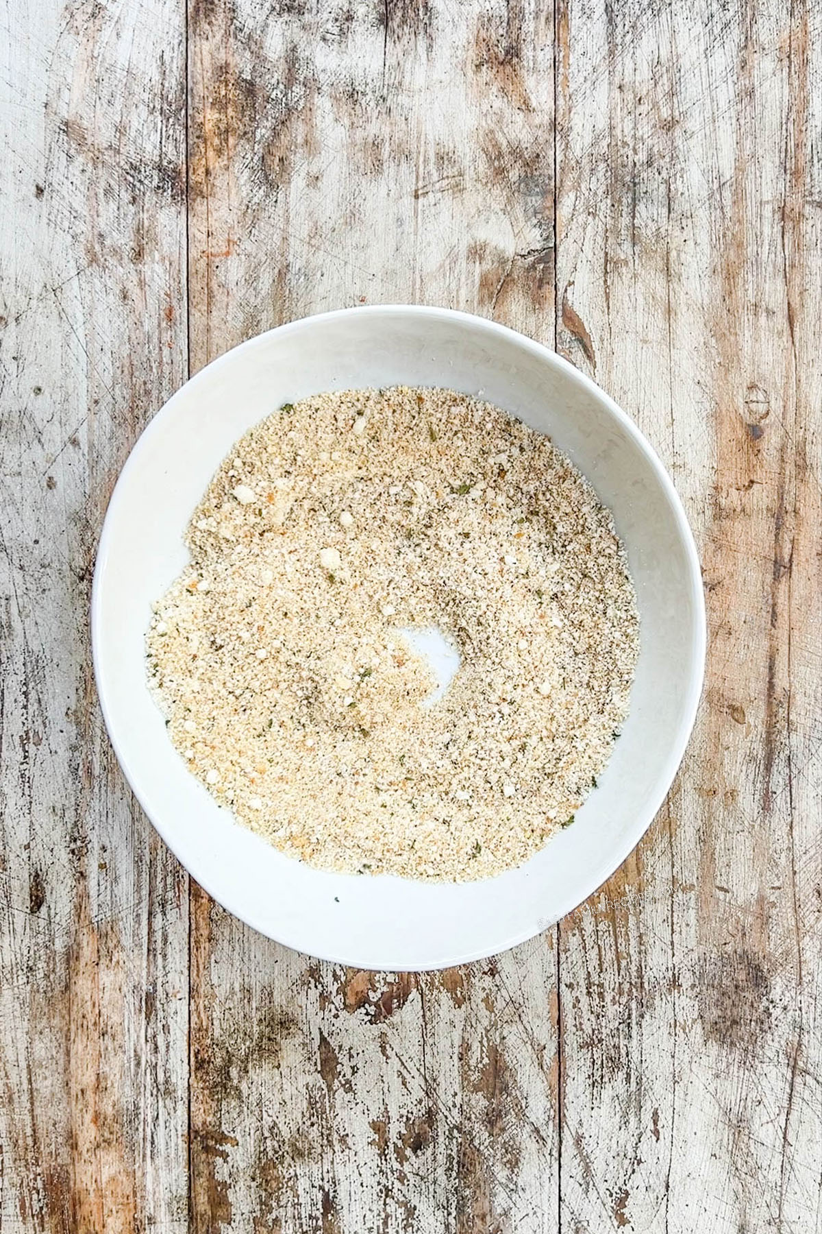 A top view of garlic Parmesan bread crumbs in a white bowl for Garlic Parmesan Chicken Pasta.