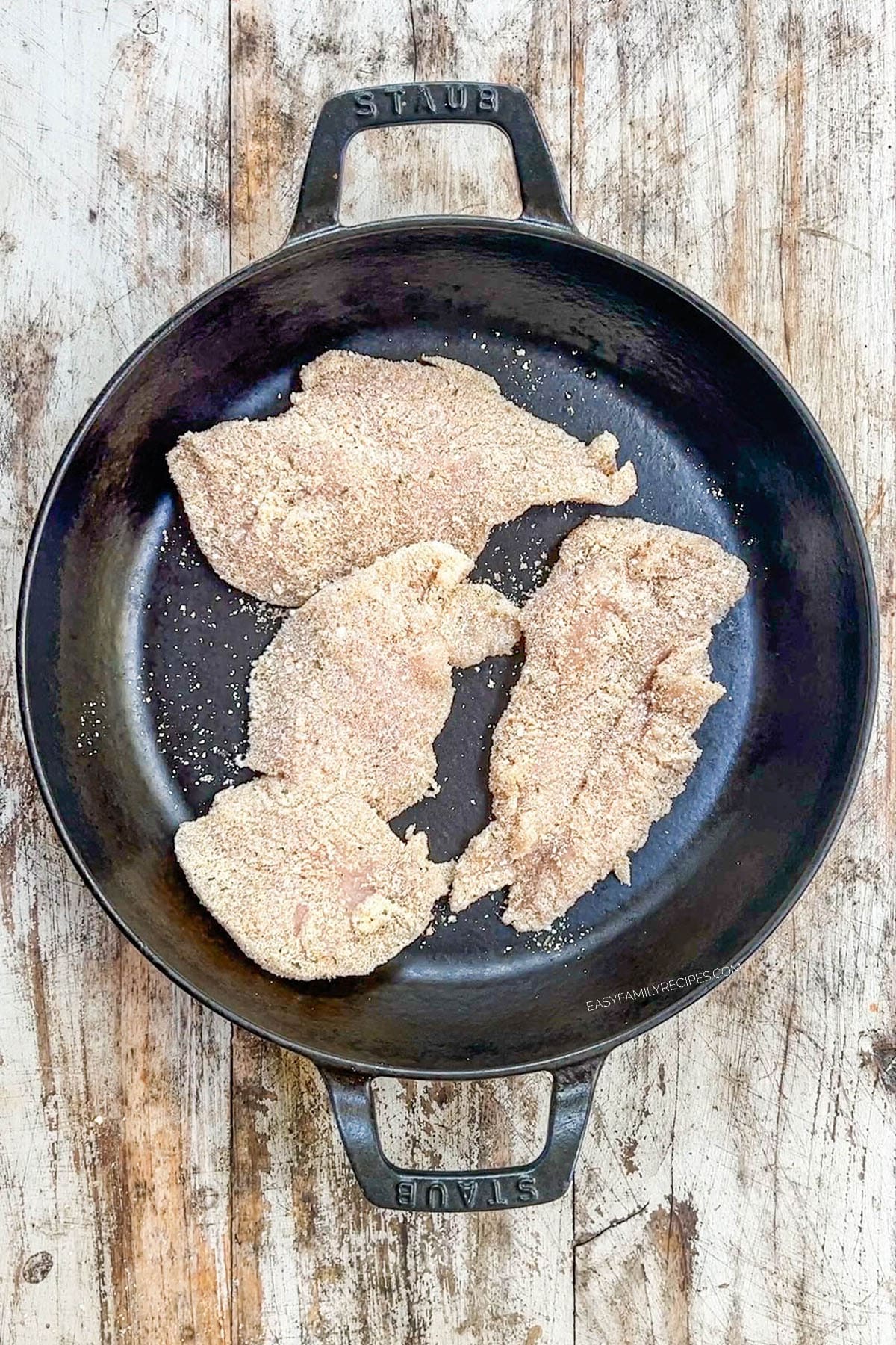 A top view of chicken breasts cooking in a skillet for Garlic Parmesan Chicken Pasta.