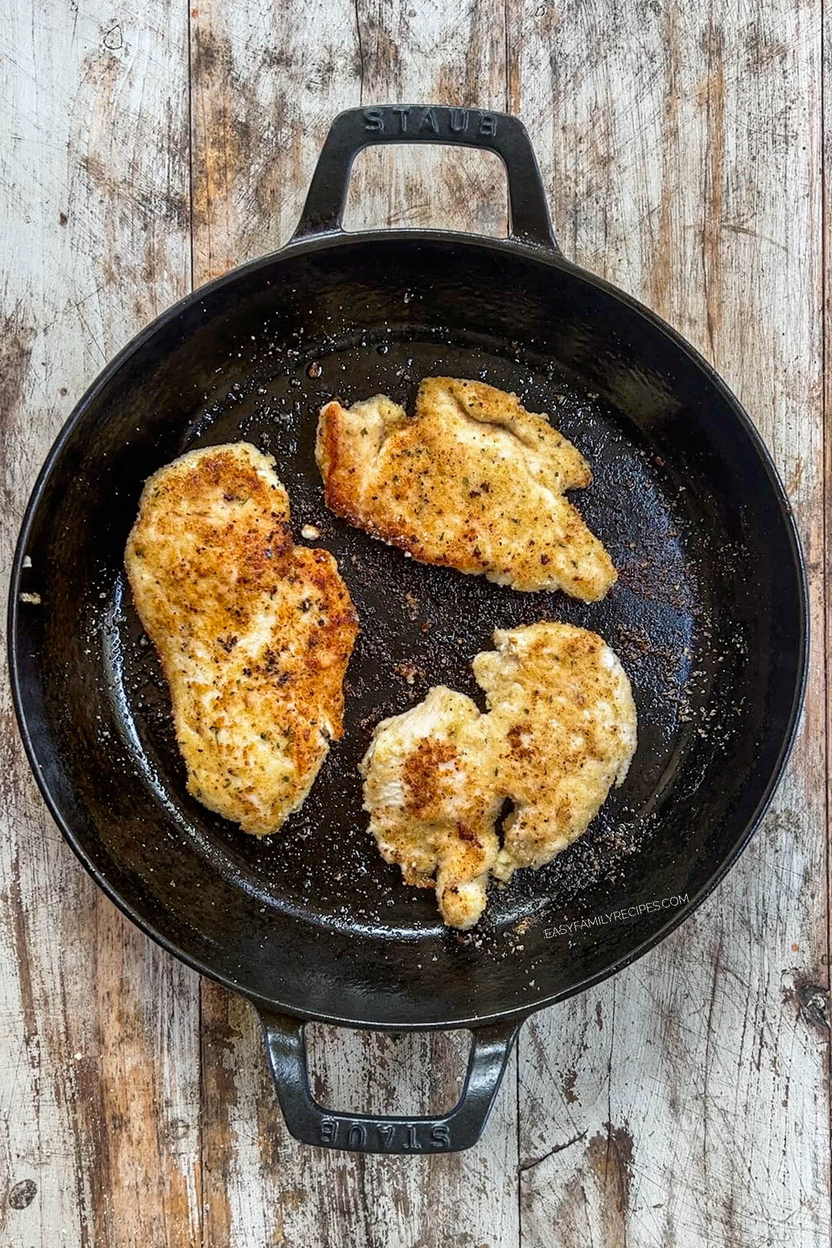 Crispy golden chicken in a skillet, ready for Garlic Parmesan Chicken Pasta.