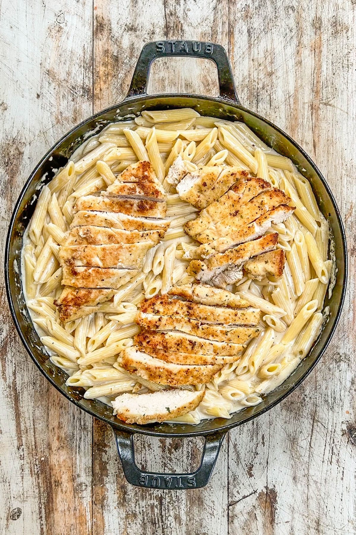 A top view of the completed dish, Garlic Parmesan Chicken Pasta, in a skillet, ready to serve.