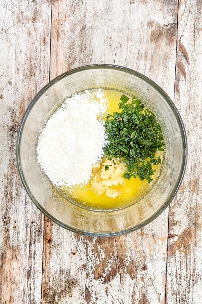 mixing bowl with melted butter, parmesan, parsley, and garlic. 