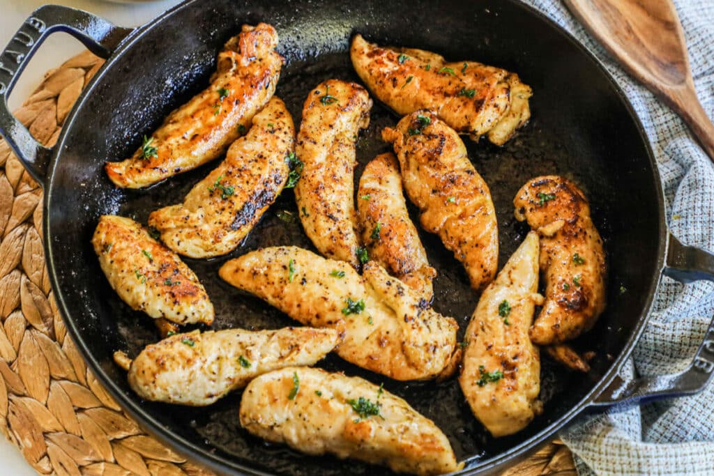 Lemon Pepper Chicken Tenders in a cast iron skillet.