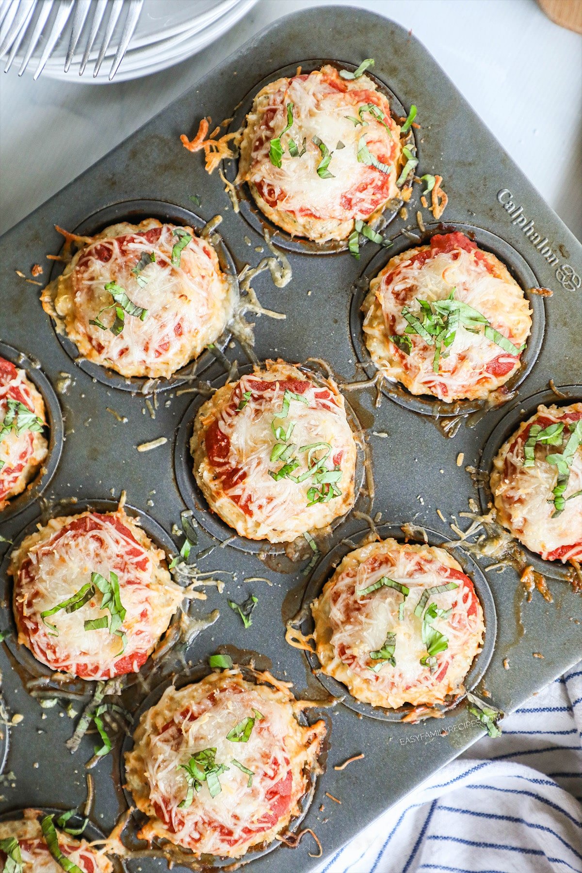 A top view of Chicken Parmesan Meatloaf Muffins in a muffin pan. 