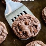 A Devil's Food Cookie is lifted off a cookie sheet by a spatula. The text reads, "Devils' Food Cookies."