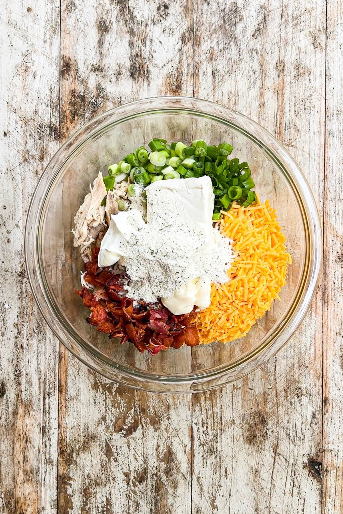 A top view of filling ingredients for Chicken Bacon Ranch Quesadillas in a glass bowl.