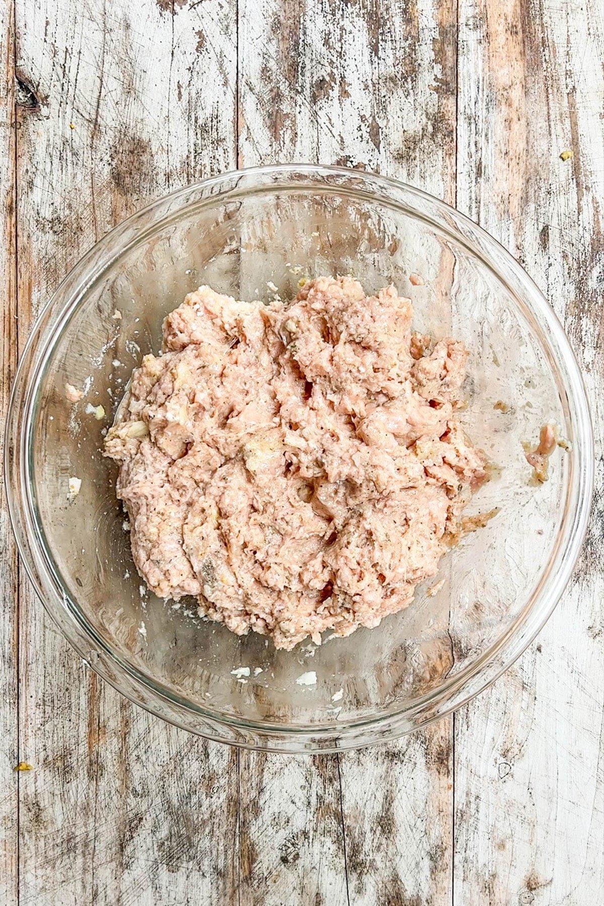 A top view of Chicken Parmesan Meatloaf Muffins being mixed together in a bowl.