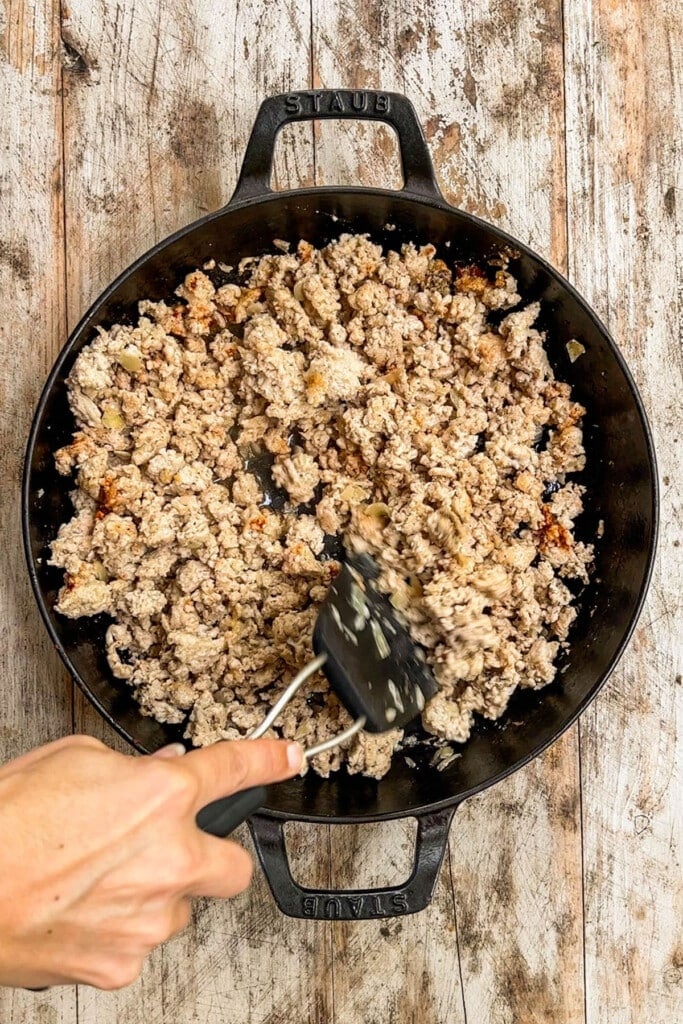 ground chicken being cooked in a skillet. 