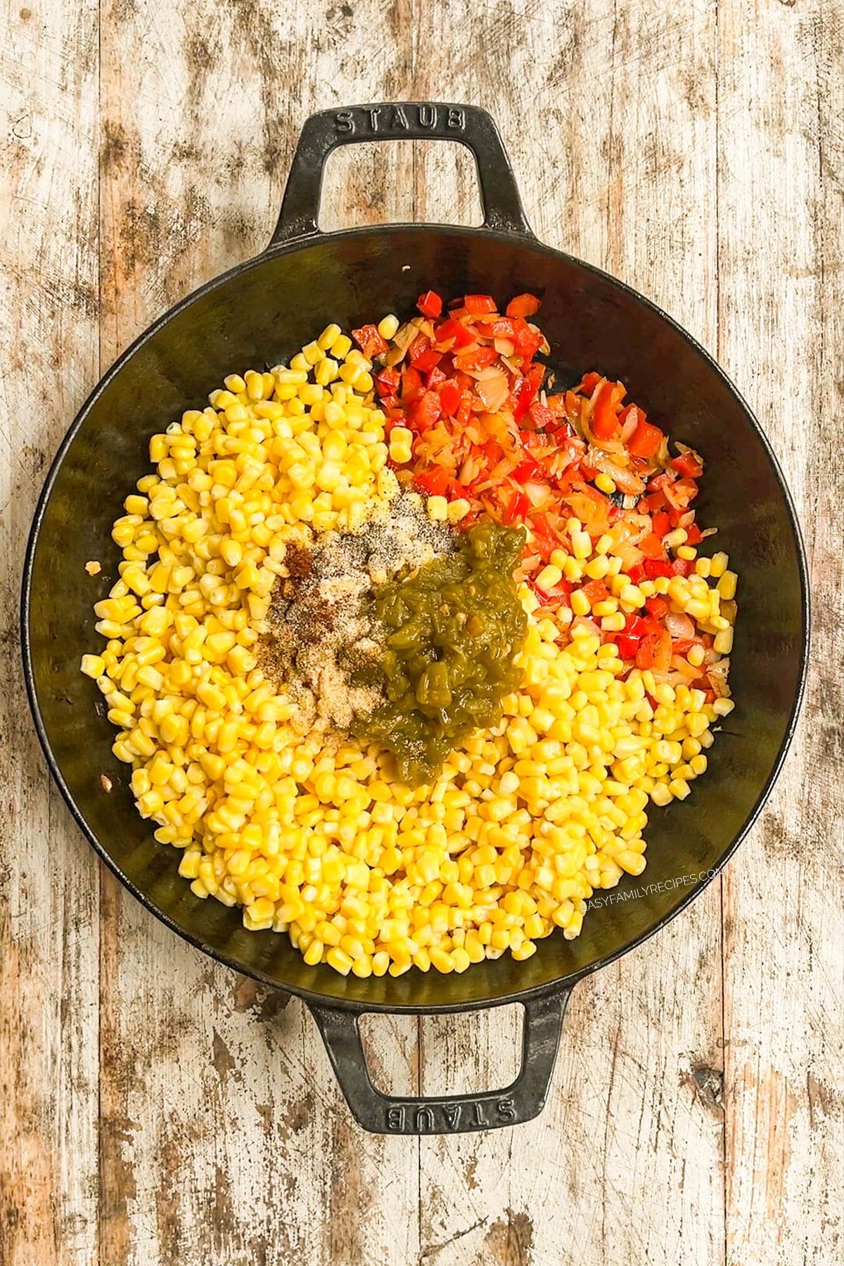 Seasonings are added to a black skillet for Southwest Corn.