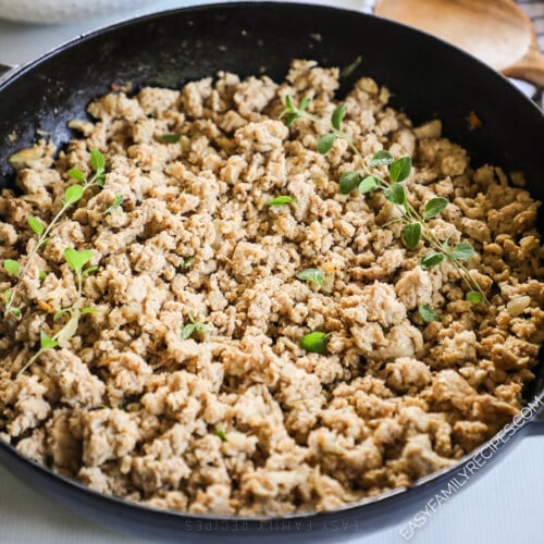 a skillet with seasoned ground chicken.