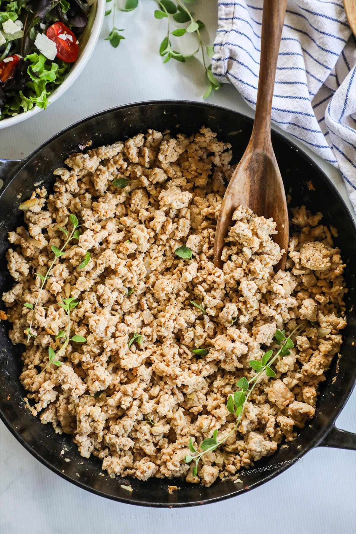 above image of a skillet filled with ground chicken. 