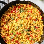 A top view of skillet corn in a black skillet with a white background. The text reads, "Southwest Corn"