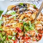 BBQ ranch chicken salad in a white bowl with a silver fork. The text reads, "BBQ Ranch Chicken Salad."