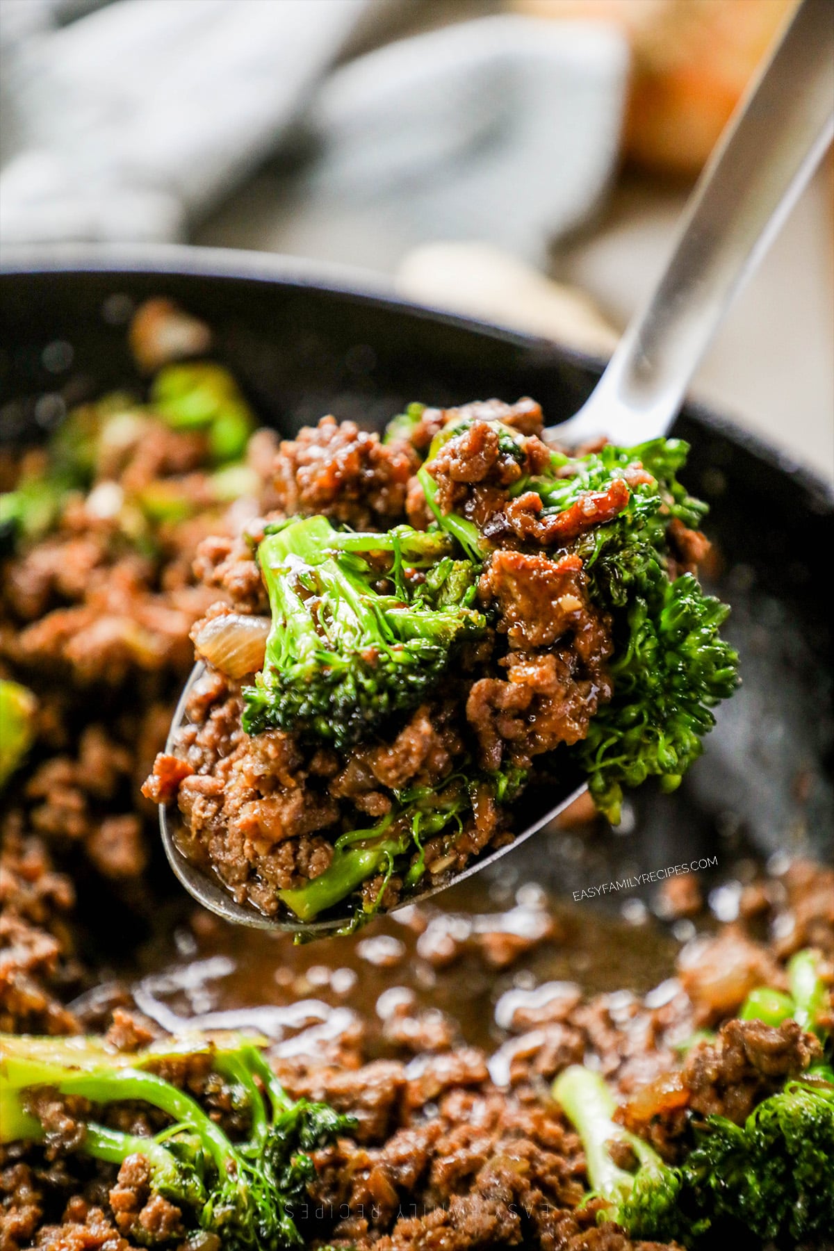 Scooping a spoonful of ground beef and broccoli.