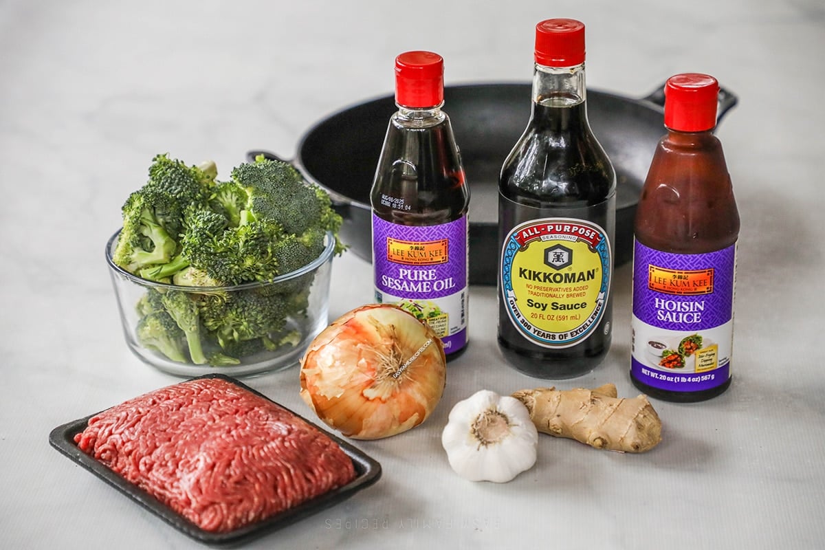 Ingredients for making easy Beef and Broccoli including ground beef, broccoli, onion, garlic, ginger, soy sauce.