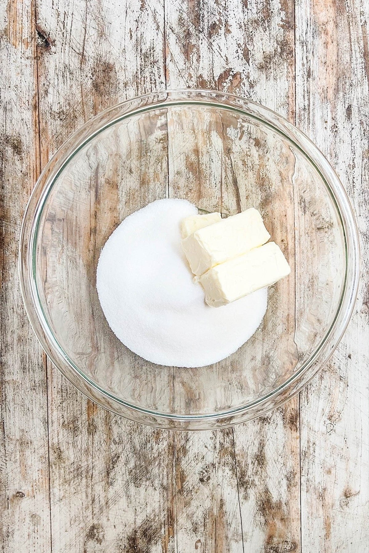 Butter and sugar are added to a bowl for step 1 of how to make chocolate marshmallow cookies.