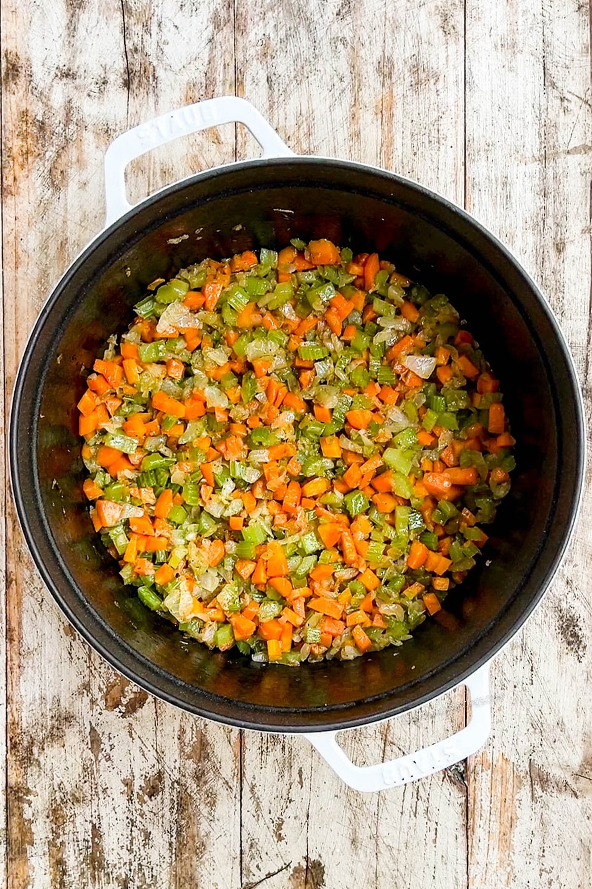 Sautéed veggies in a Dutch oven for Creamy Lemon Chicken Orzo Soup.