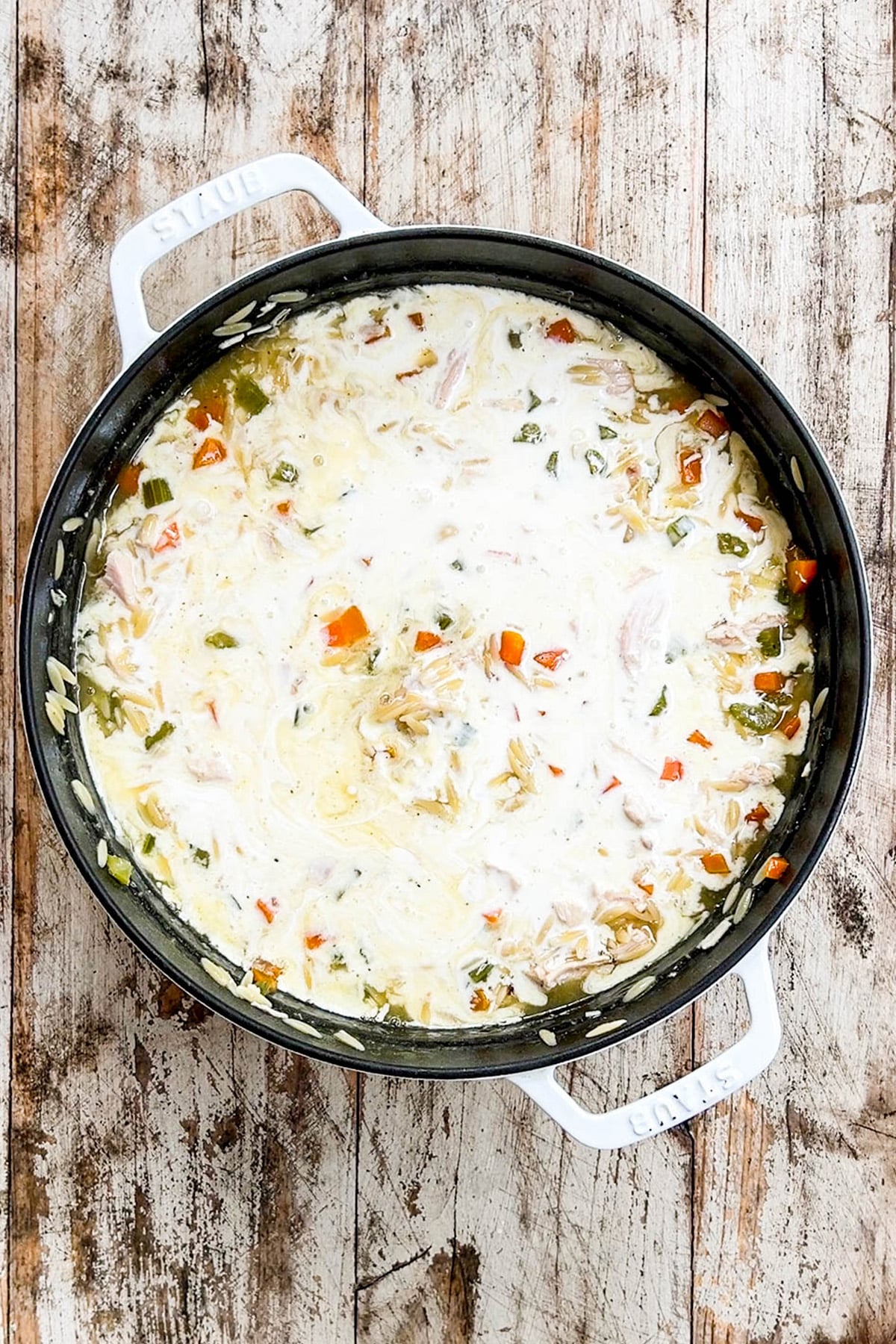 Cream is added to the recipe for Creamy Lemon Chicken Orzo Soup.