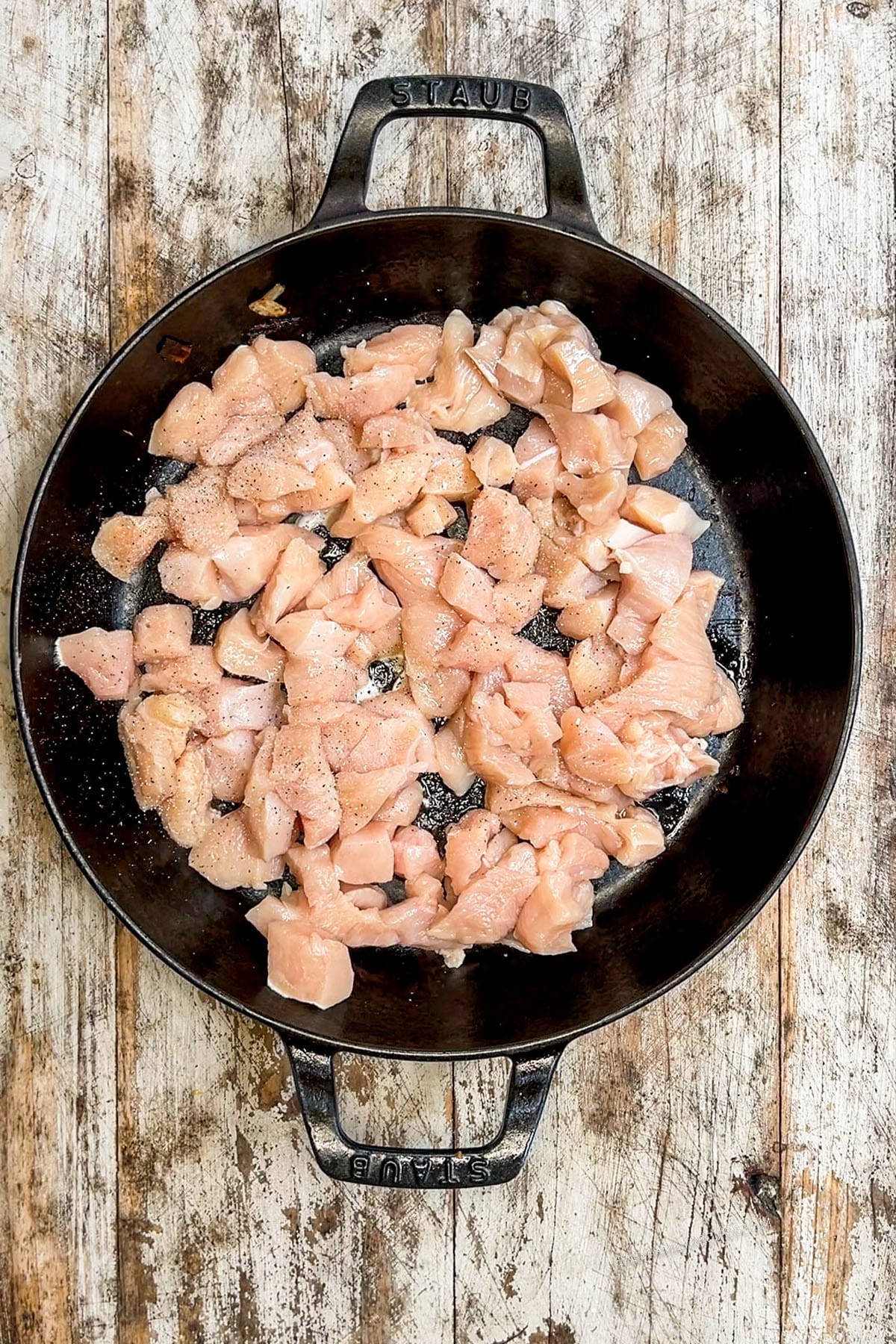 Step 2 of making Hibachi Chicken: The chicken is added to the skillet.