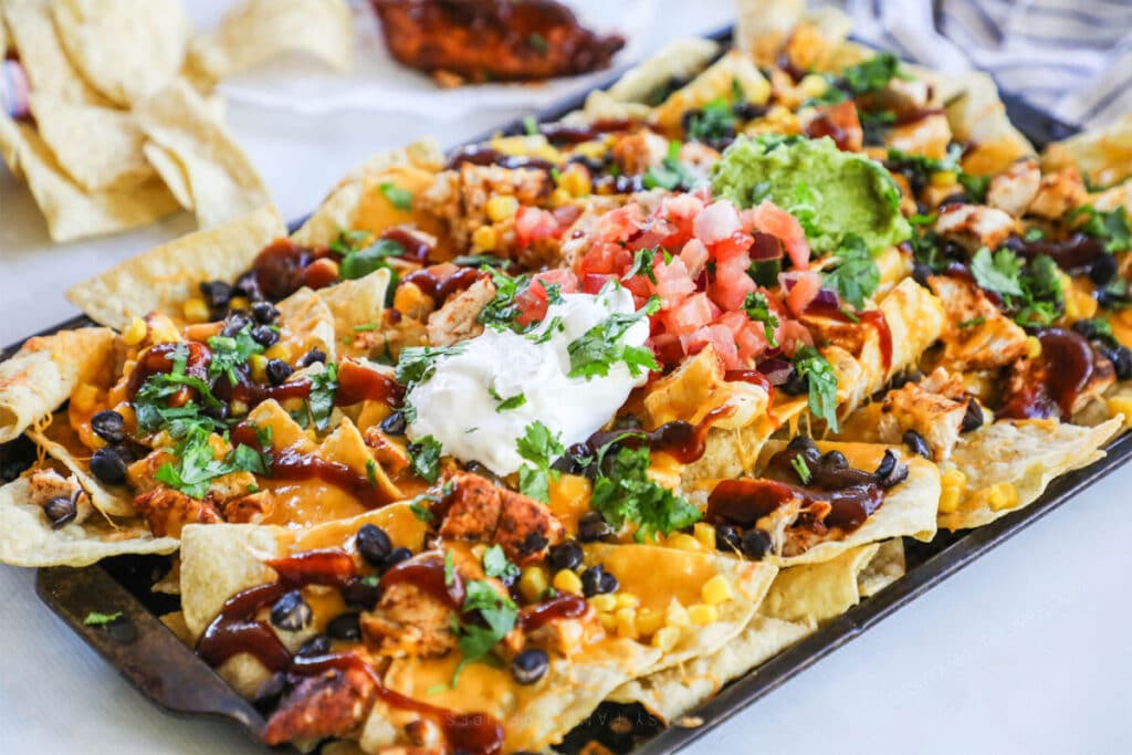 Baked BBQ Chicken Nachos recipe prepared on a sheet pan.