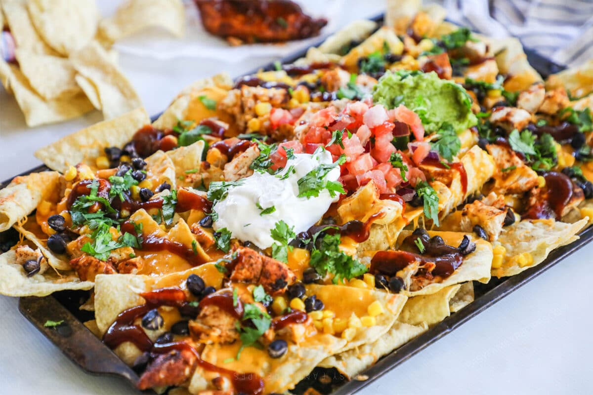 Baked BBQ Chicken Nachos recipe prepared on a sheet pan.