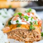 Half of a chimichanga on a white plate with rice. The text reads, “Baked Chicken Chimichangas.”