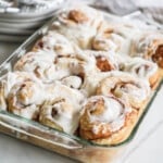 side view of a pan of baked cinnamon rolls.