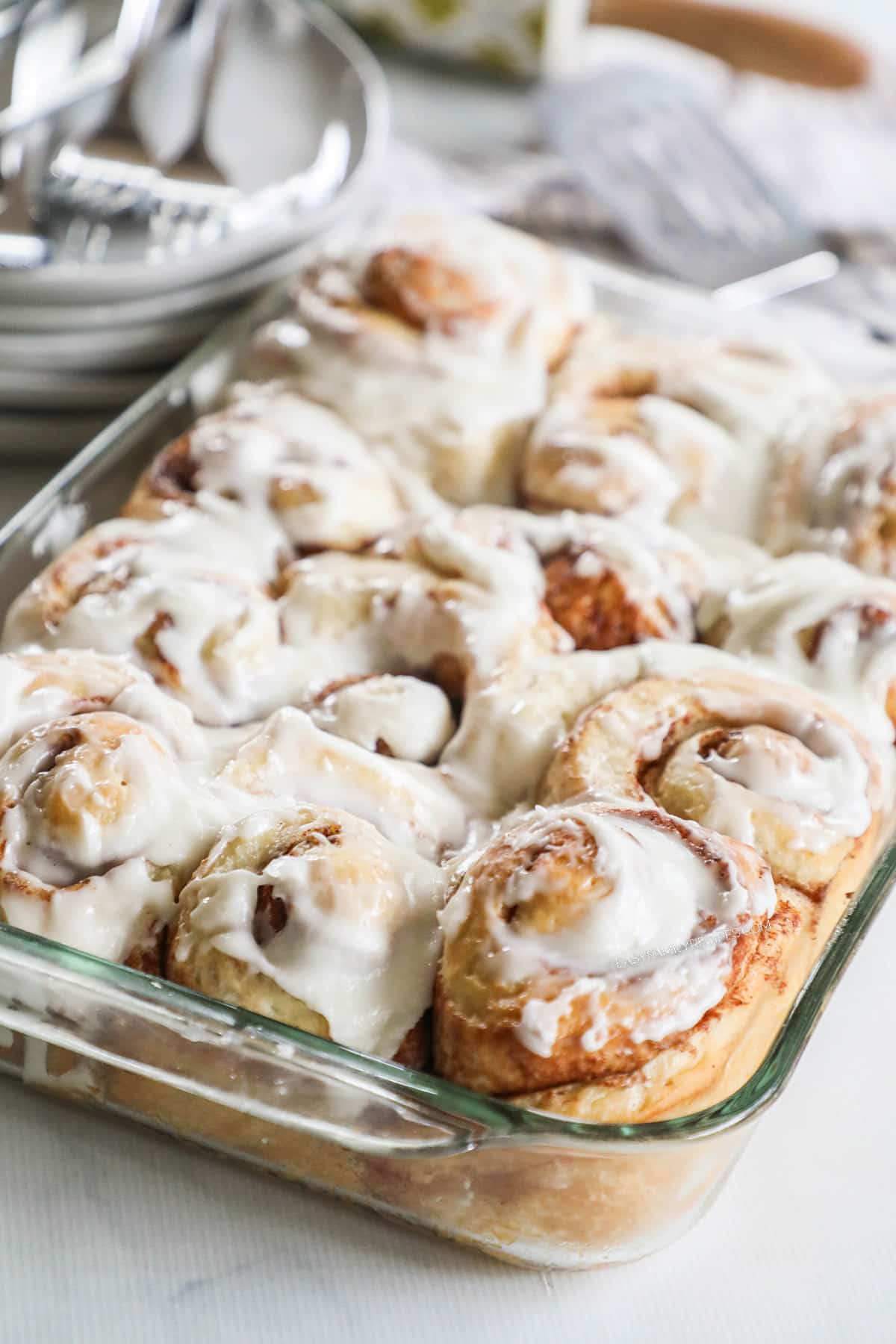 side view of a pan of baked cinnamon rolls.