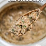 A slow cooker full of Beef Stroganoff, being stirred with a wooden spoon. The text reads, "Crockpot Beef Stroganoff."