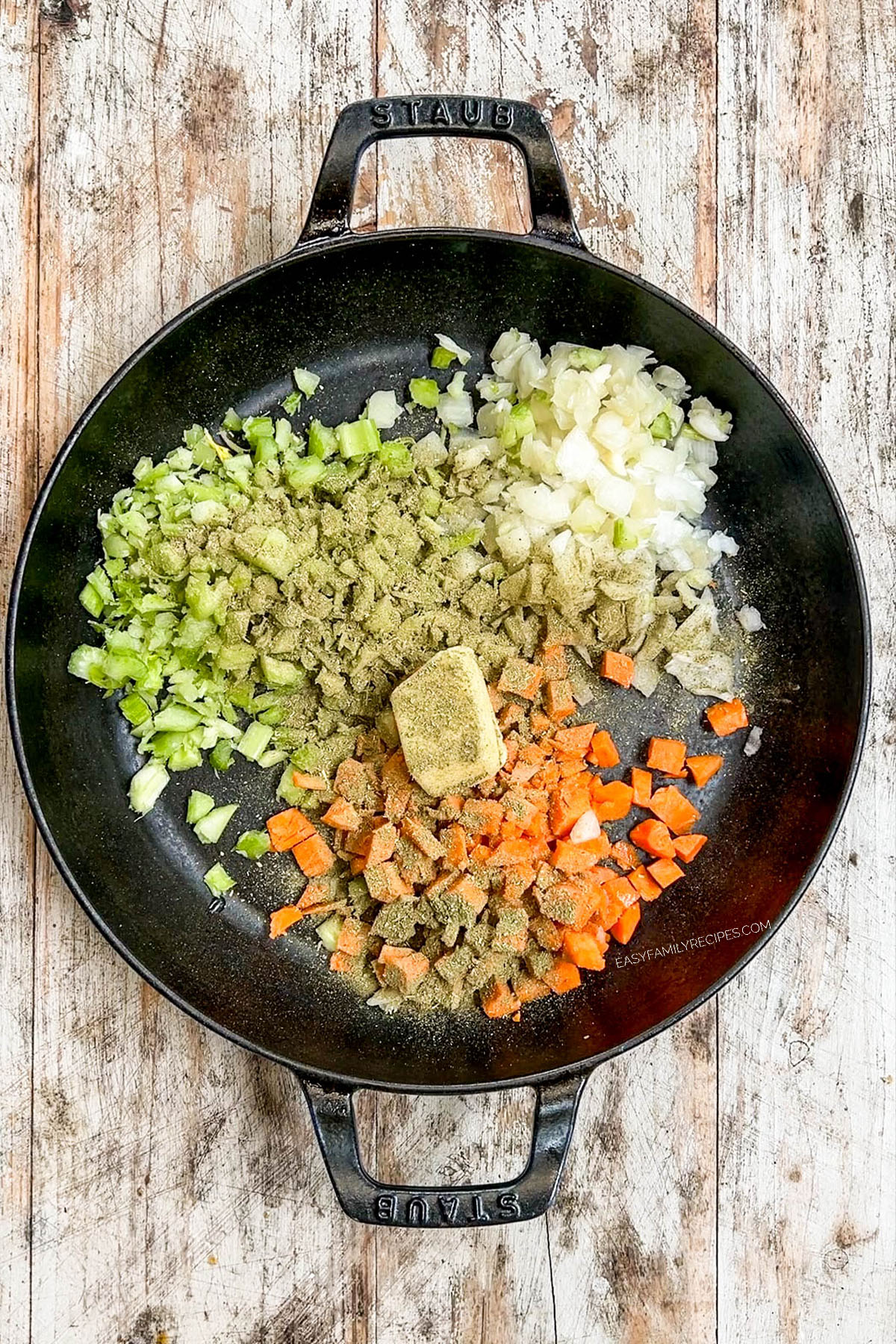 Step 1 of making chicken pot pie: Veggies and seasonings are sautéed in a skillet.