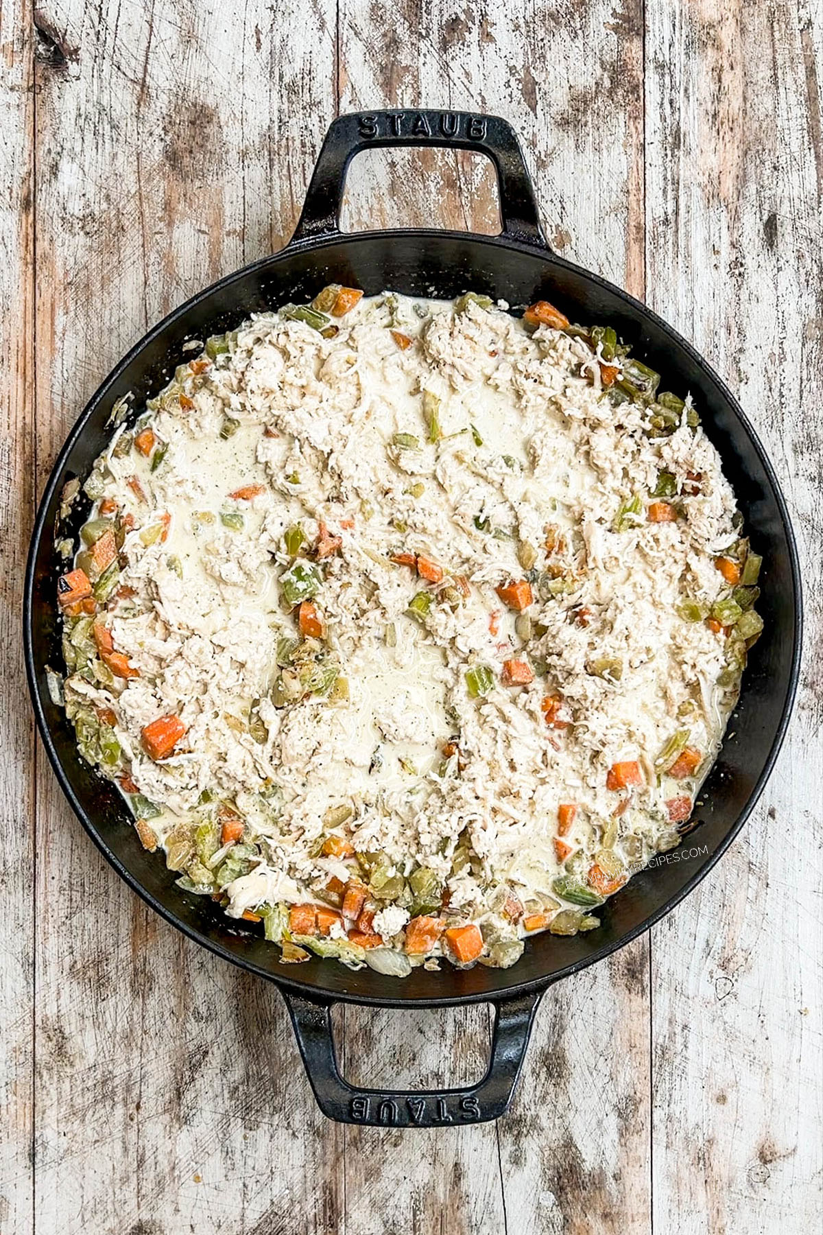 Step 4 of making chicken pot pie: The filling has been made in a black skillet.