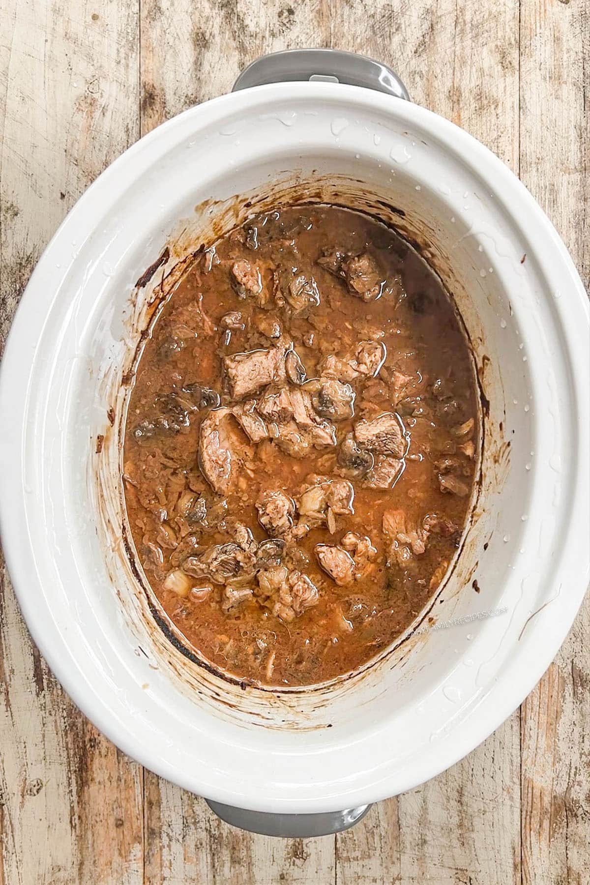 Step 4 of making beef stroganoff in the slow cooker, skim off the fat.