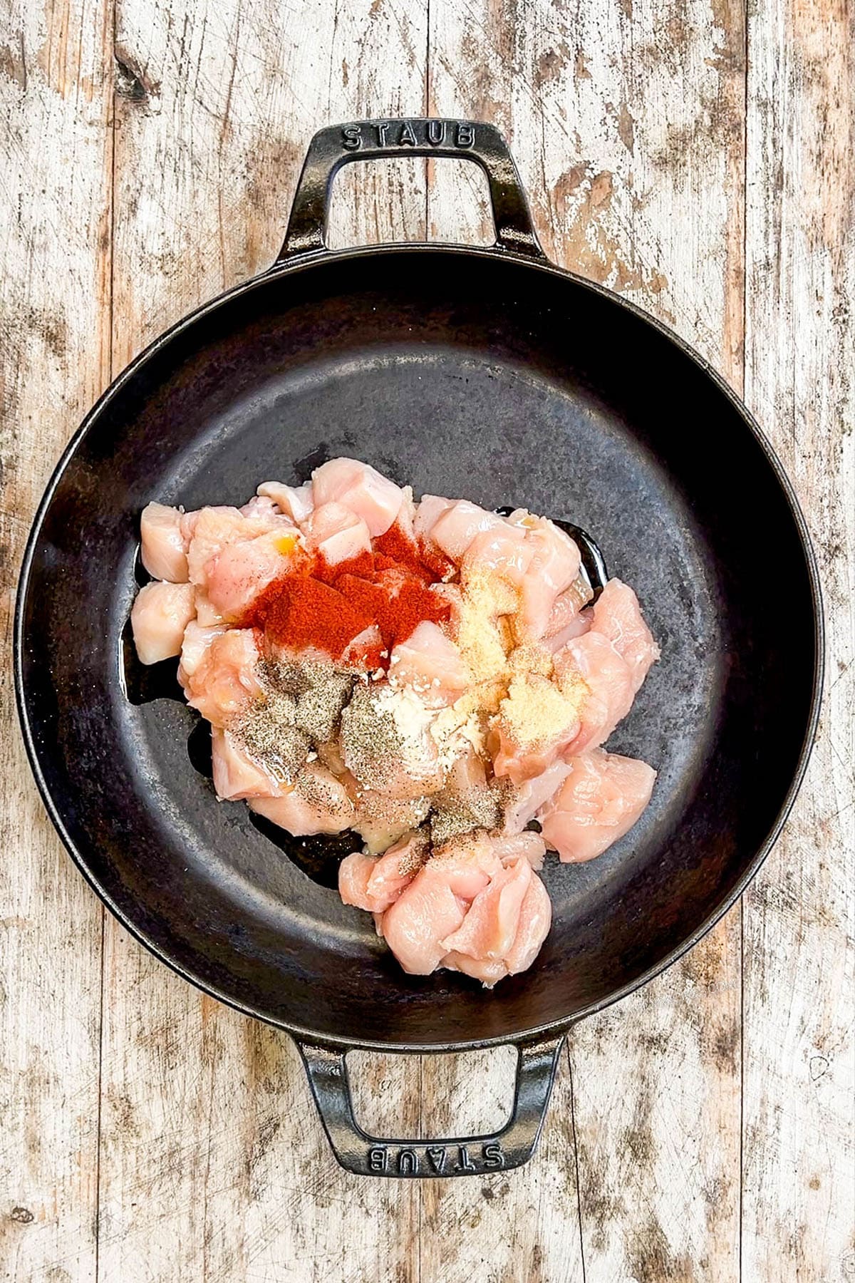 Ingredients for garlic butter chicken bites in a skillet, ready to cook.