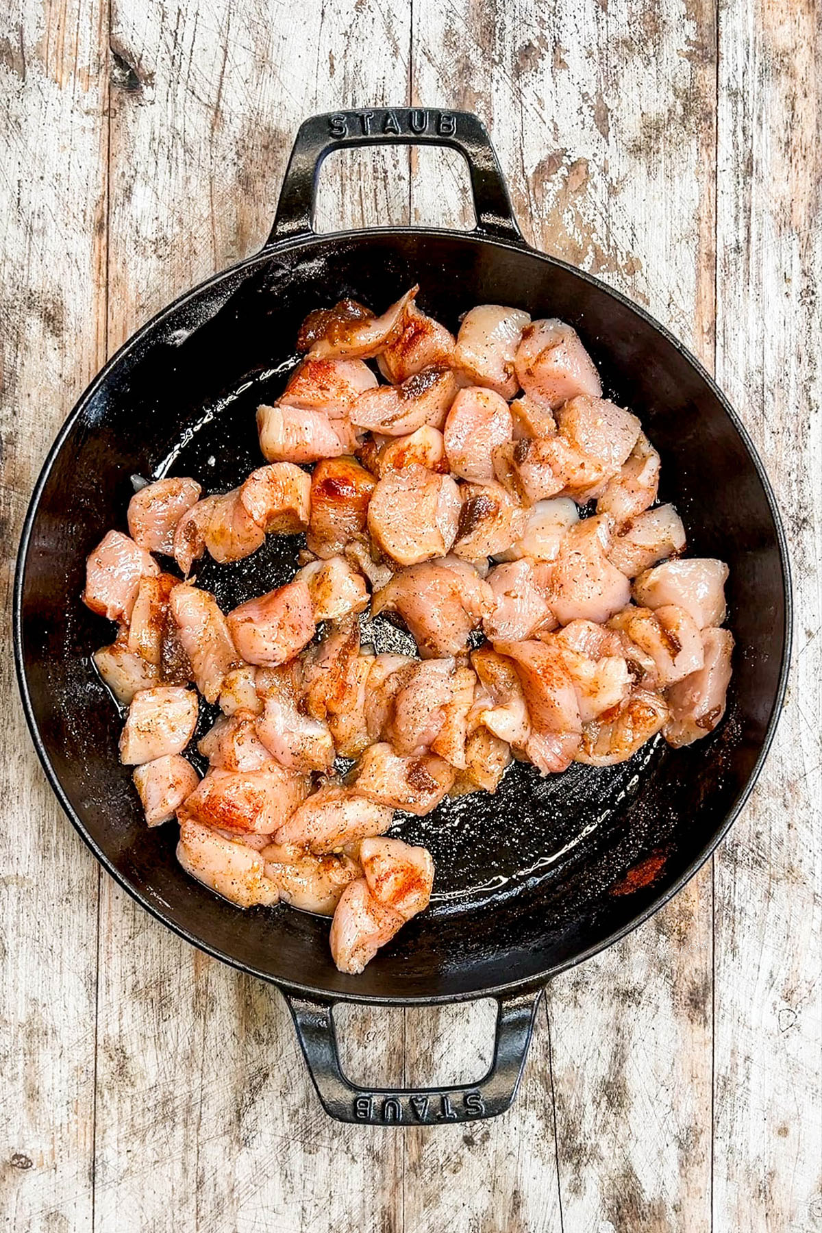 Garlic butter chicken bites, ready to sear, in a skillet.