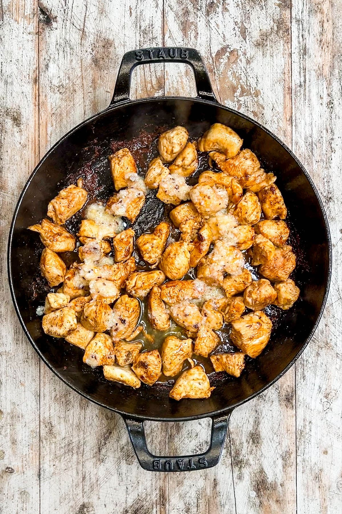 Seared garlic butter chicken bites in a skillet.