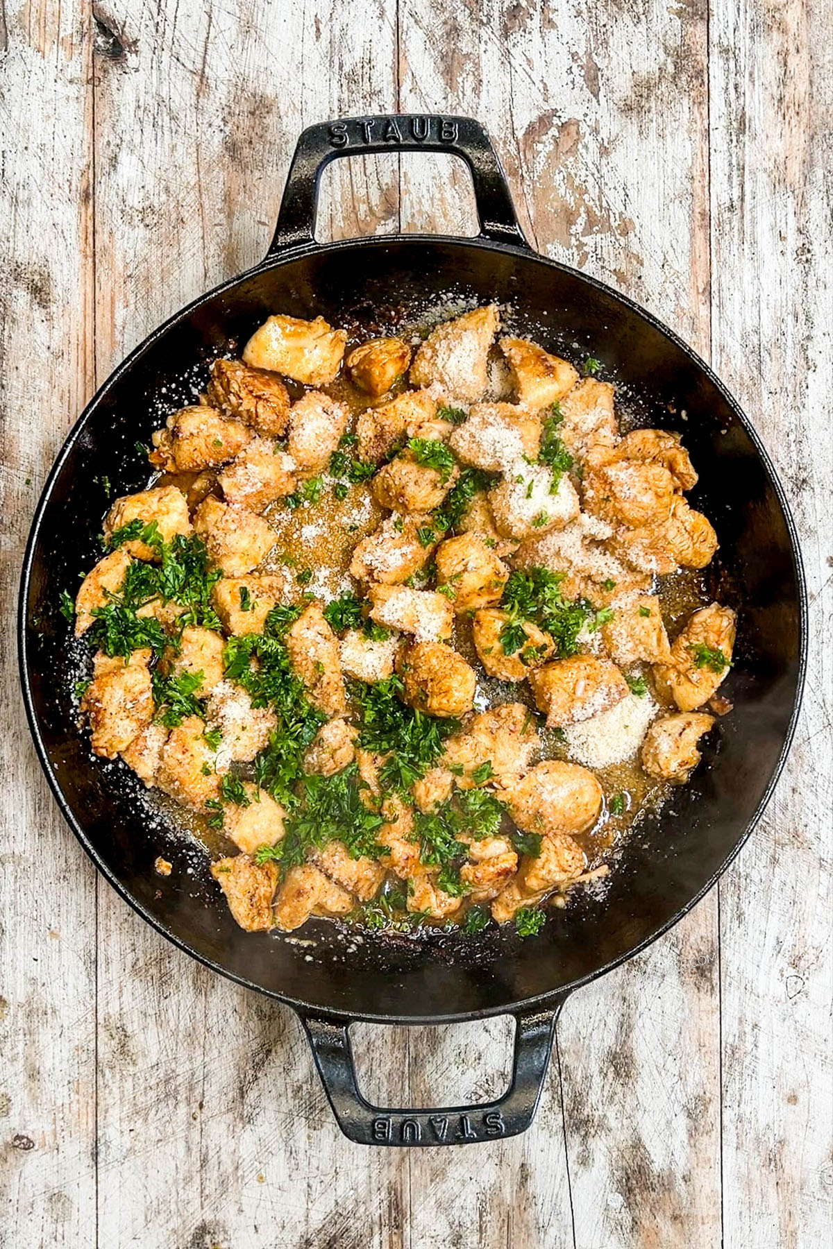 The buttery sauce is poured over garlic butter chicken bites.