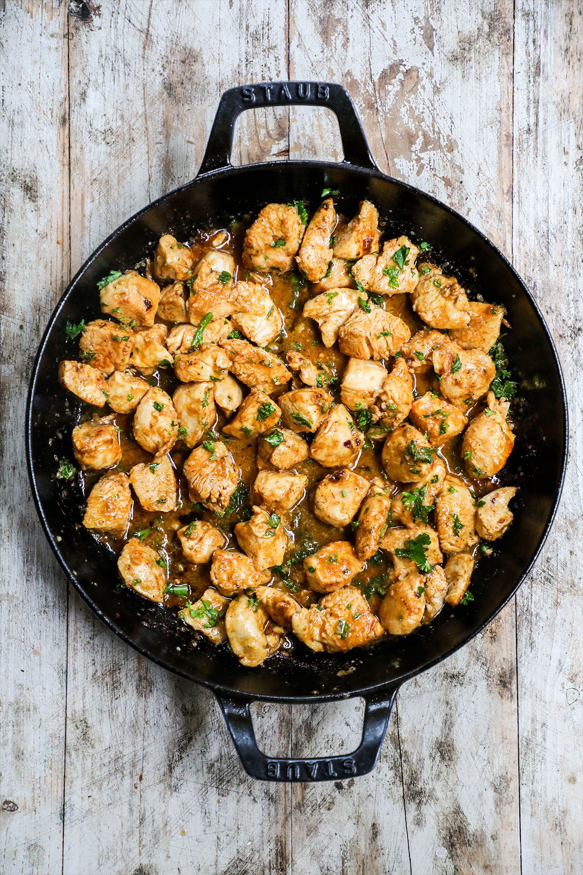 Garlic butter chicken bites in a skillet.