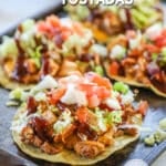 BBQ Chicken Tostadas on a sheet pan. The text reads, "BBQ Chicken Tostadas."