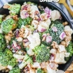 Easy Broccoli Cauliflower Salad prepared with Craisins and sunflower seeds.