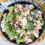 Bowl of broccoli cauliflower salad ready to serve for potluck.