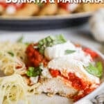 Burrata Chicken Parmesan with basil and pasta on a white plate. The text reads, "Chicken Cutlets with Burrata & Marinara."