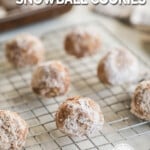 Cinnamon snowball cookies on a silver wire rack. The text reads, “Cinnamon Snowball Cookies.”