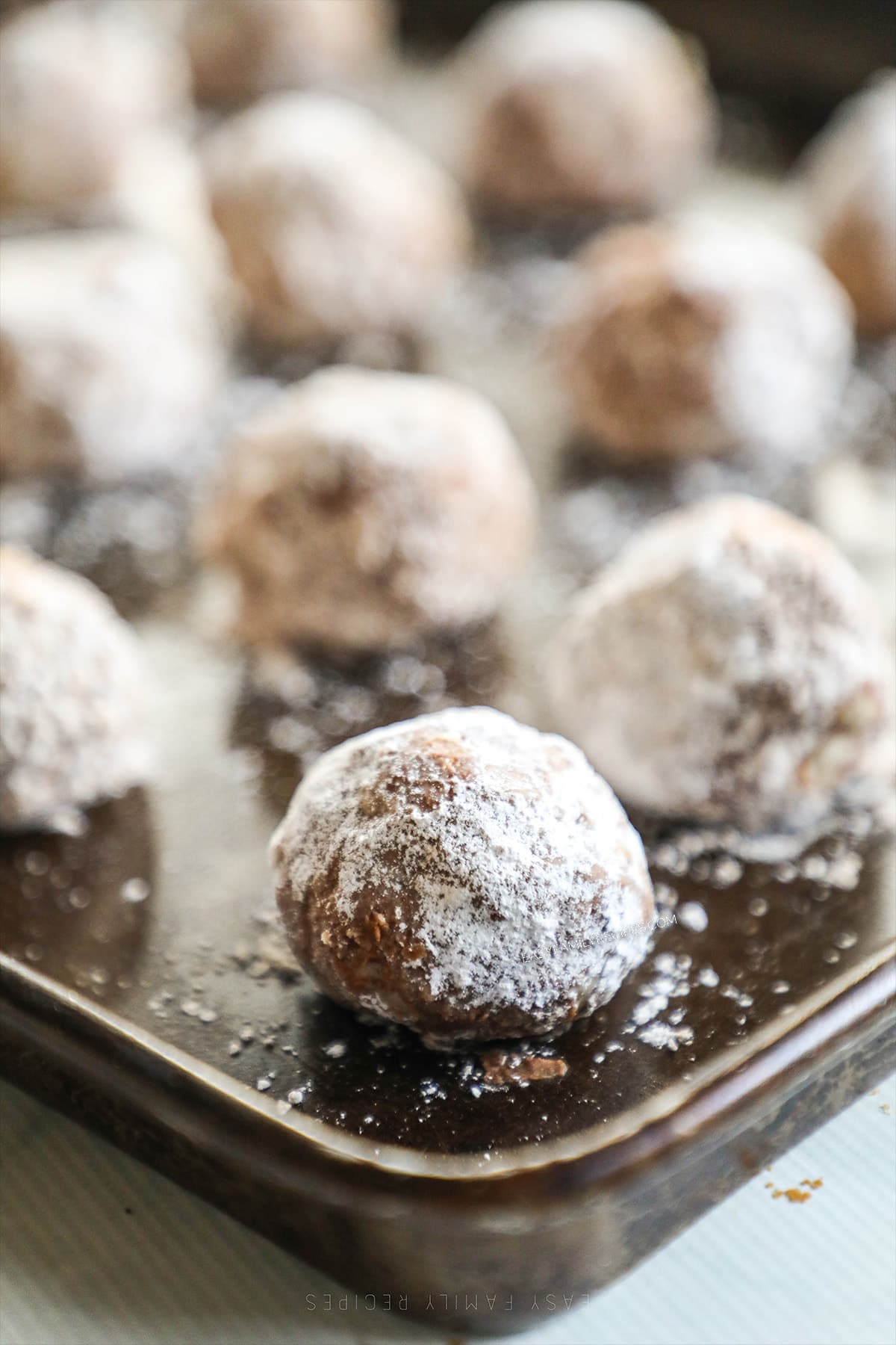 Cinnamon Snowball Cookies on a metal baking sheet.