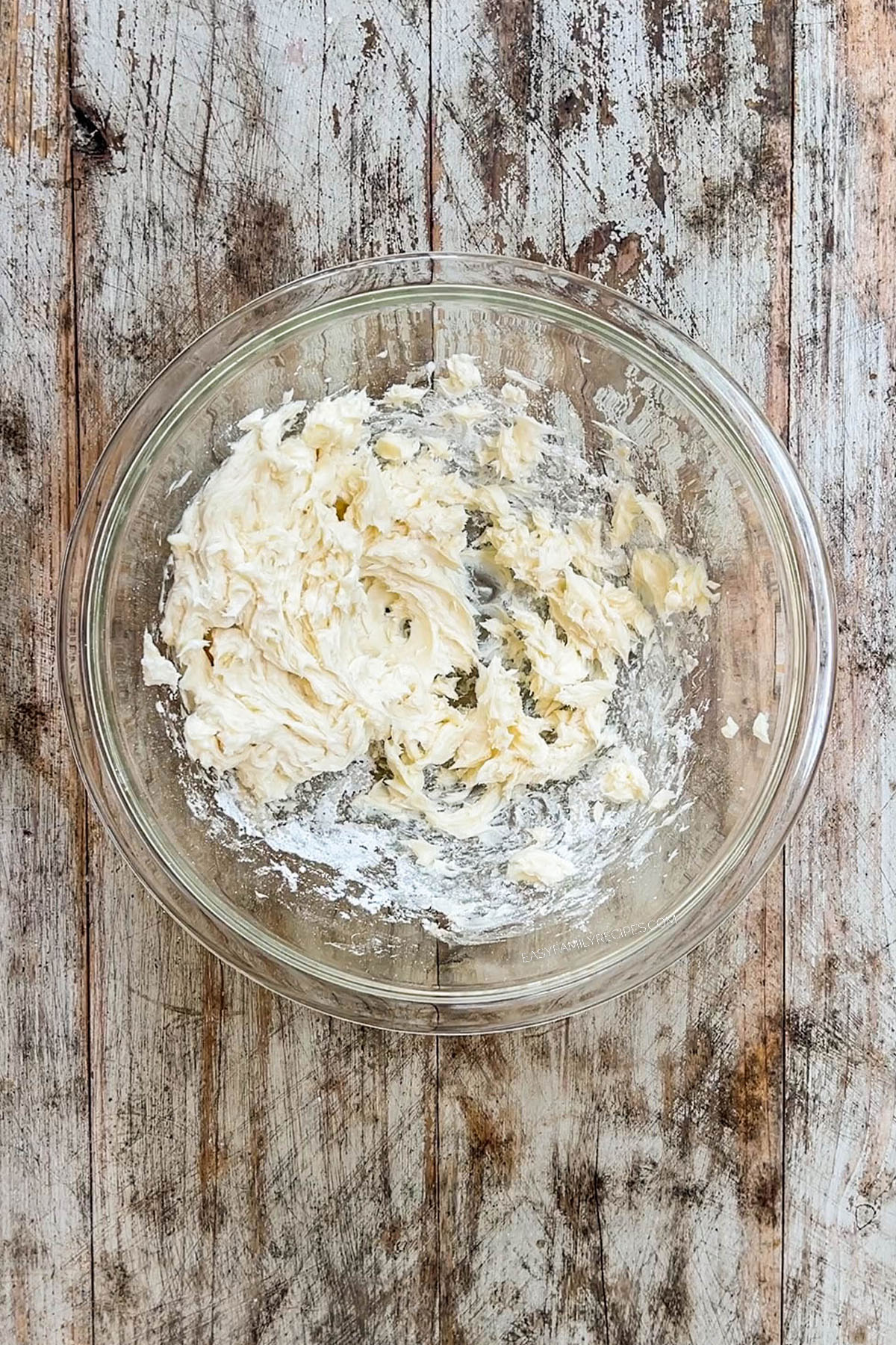 Step 2 to making Cinnamon Snowball Cookies - cream together the butter and powdered sugar.