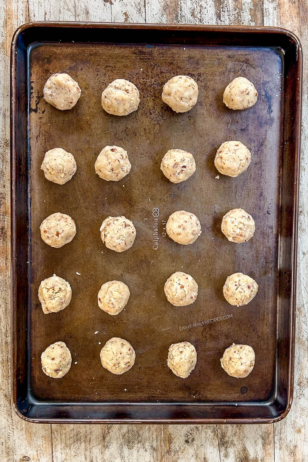 Dough for Cinnamon Snowball Cookies on a baking sheet, ready to bake.