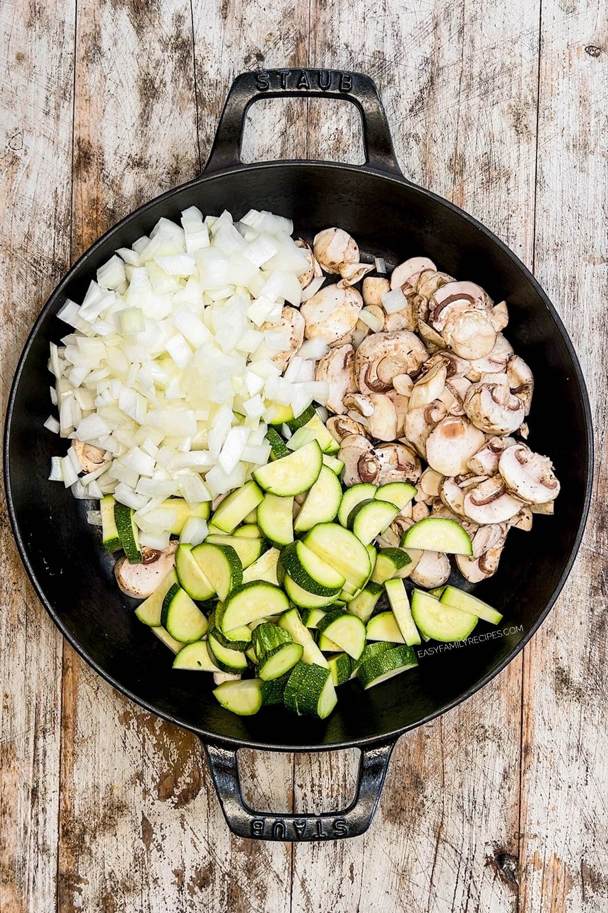 Ingredients for hibachi bowls in a black skillet, ready to cook.