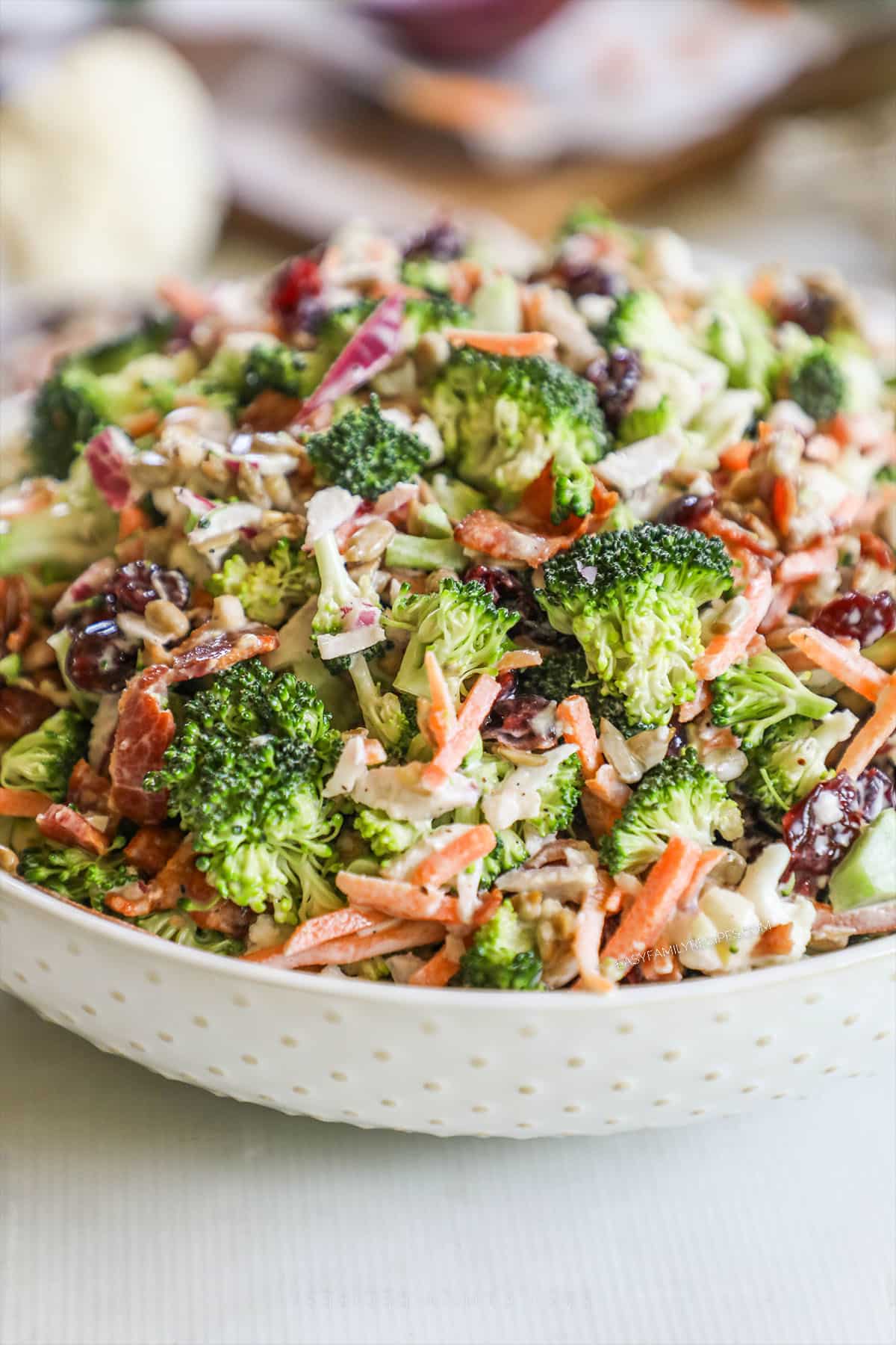 A white bowl filled with Broccoli Crunch Salad