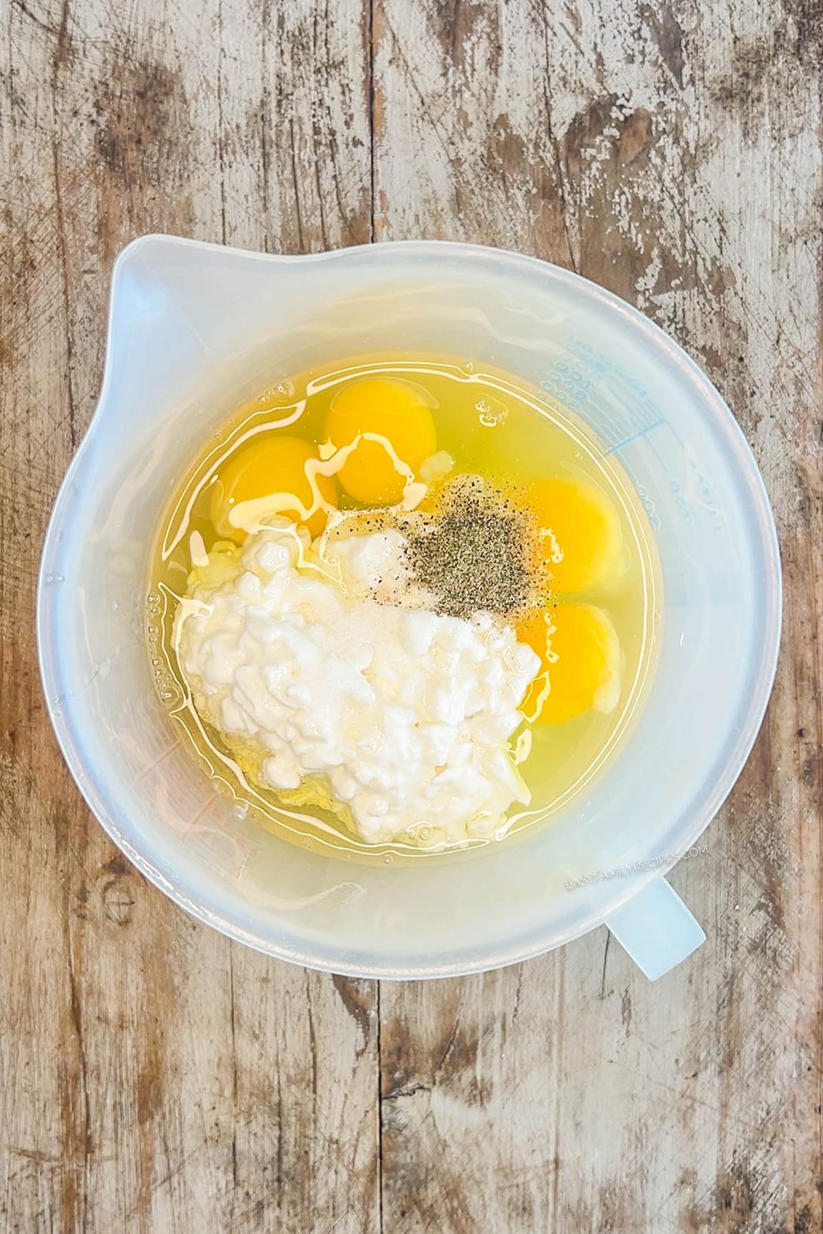 Ingredients for cottage cheese egg bites in a mixing bowl.